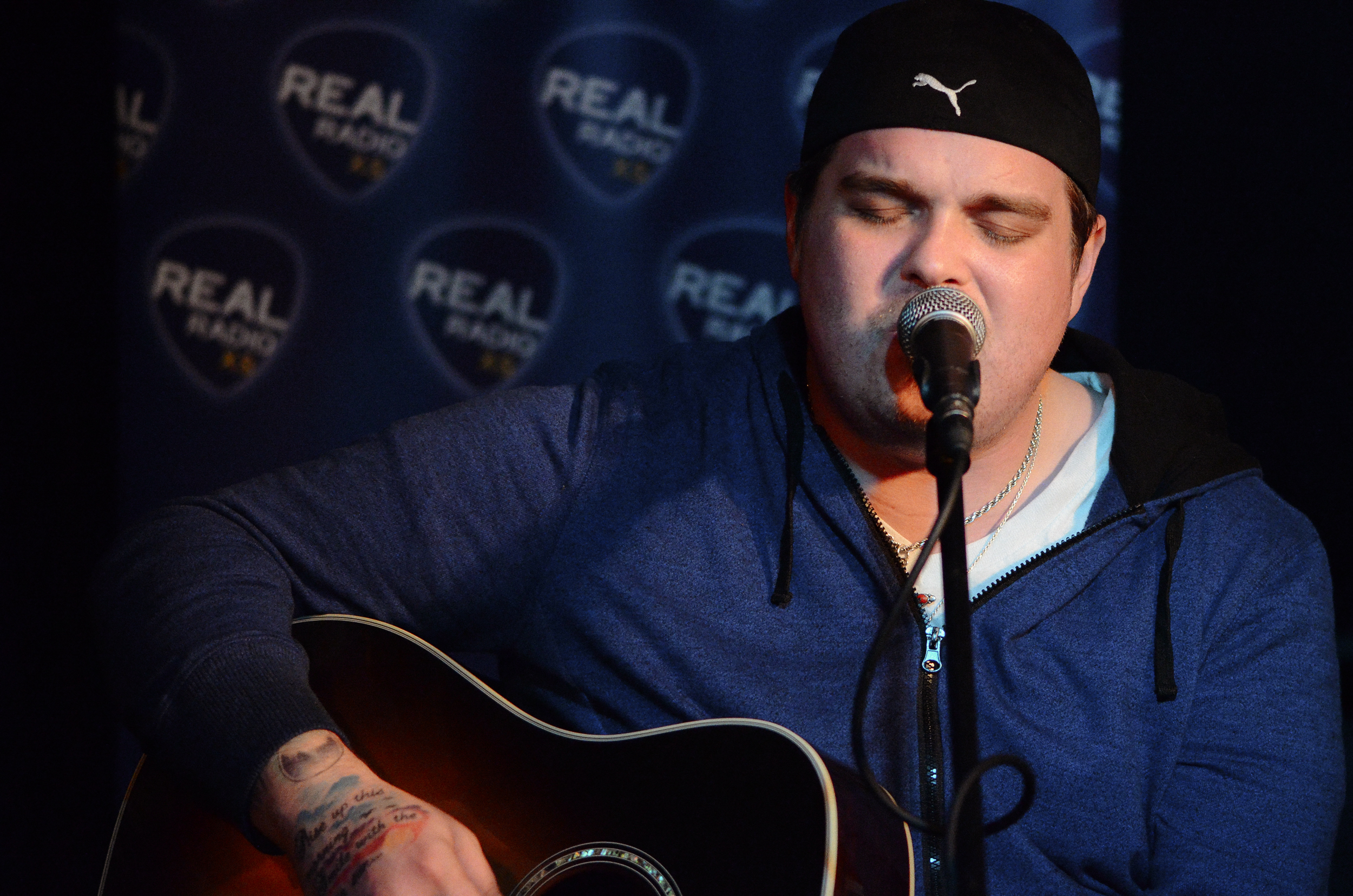 A singer with an acoustic guitar